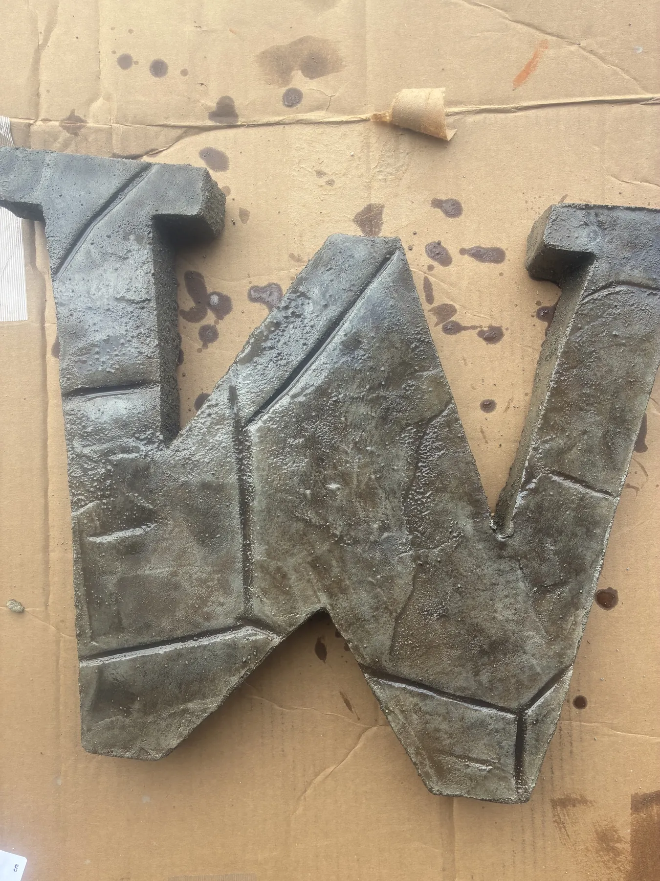 Large letter W formed from textured decorative concrete sections