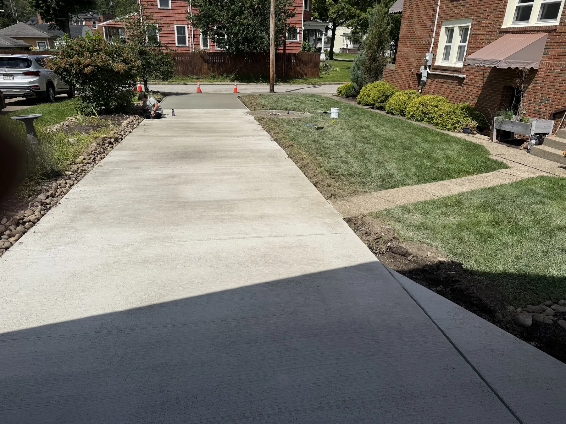Fresh concrete driveway approach leading to a garage